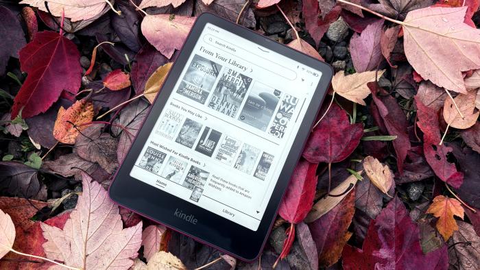 The Kindle Paperwhite Signature Edition hangs out on a bed of fallen leaves. 