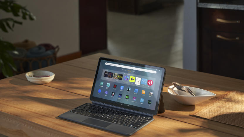 The Fire Max 11 tablet propped up by the kickstand on the back of its case, with a keyboard in front of the screen.