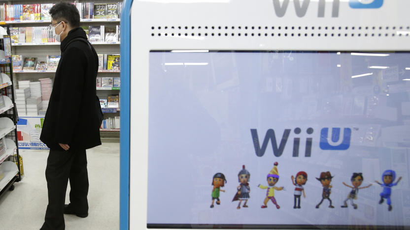 A shopper is seen behind a advertisement board of Nintendo Co Ltd's Wii U game console at an electronics retail store in Tokyo January 29, 2014. Nintendo Co Ltd, facing a third year of losses, is getting lots of unsolicited advice on how to squeeze more out of its Mario franchise and revive its fortunes after admitting that its Wii U game console has been a flop. REUTERS/Yuya Shino (JAPAN - Tags: BUSINESS SCIENCE TECHNOLOGY)