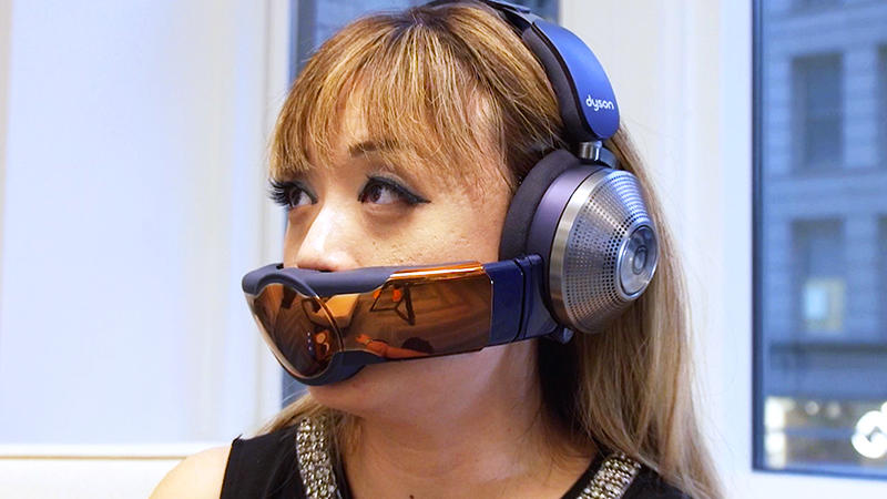 A woman wearing the Dyson Zone headphone and air filter combo unit.