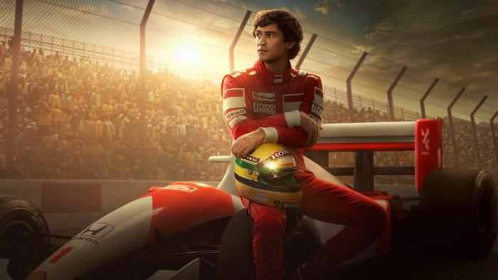 Series promotional art for Senna. The driver (Gabriel Leone) sits on his car with a crowd behind and a dramatic sun.