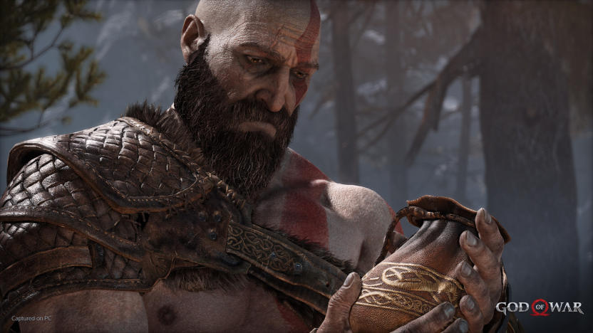 Still from the 2018 God of War game. Kratos looks down mournfully at his late wife’s urn.